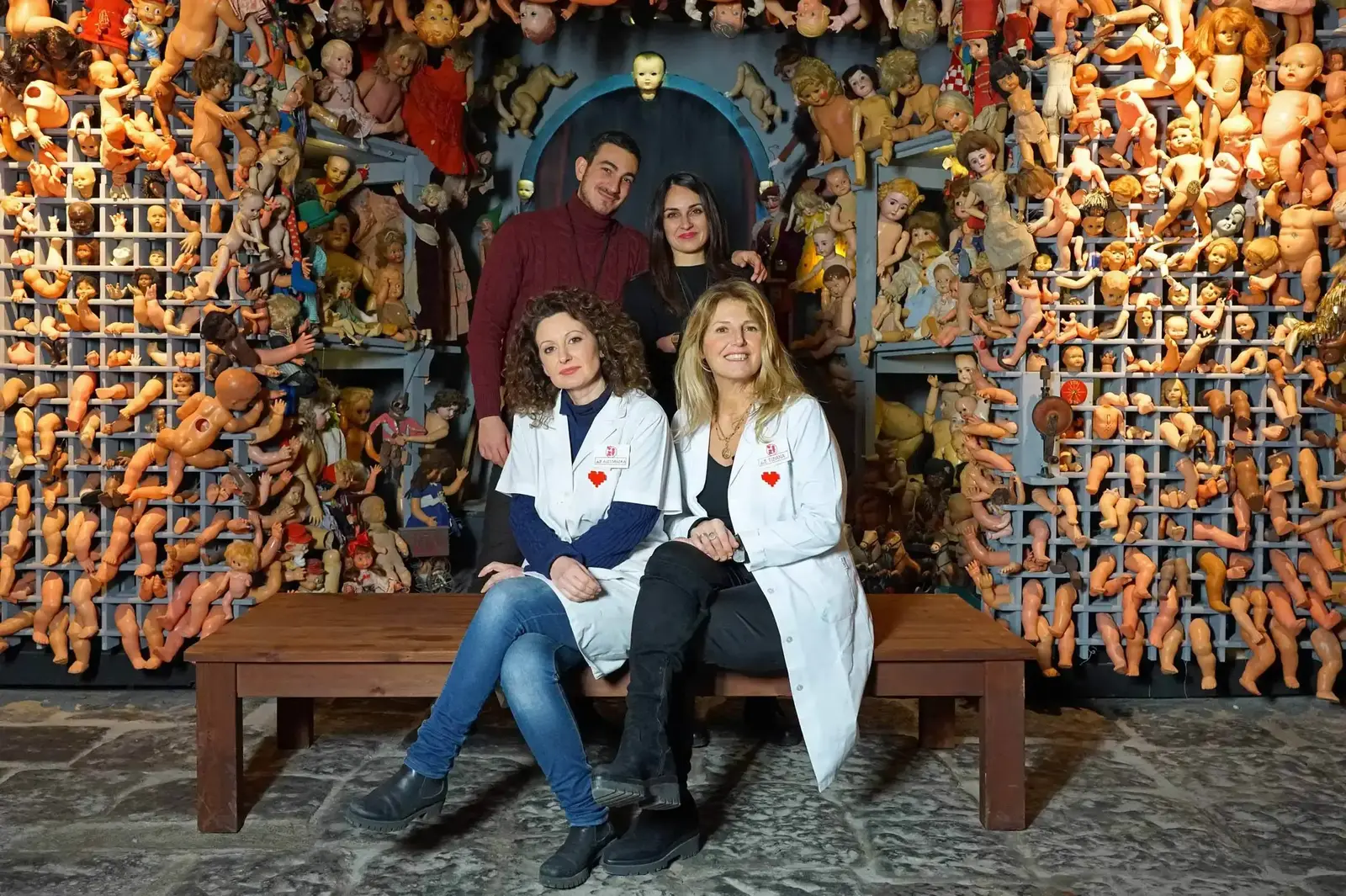 Dolls Hospital Naples - Photo of the team with dolls parts in the background