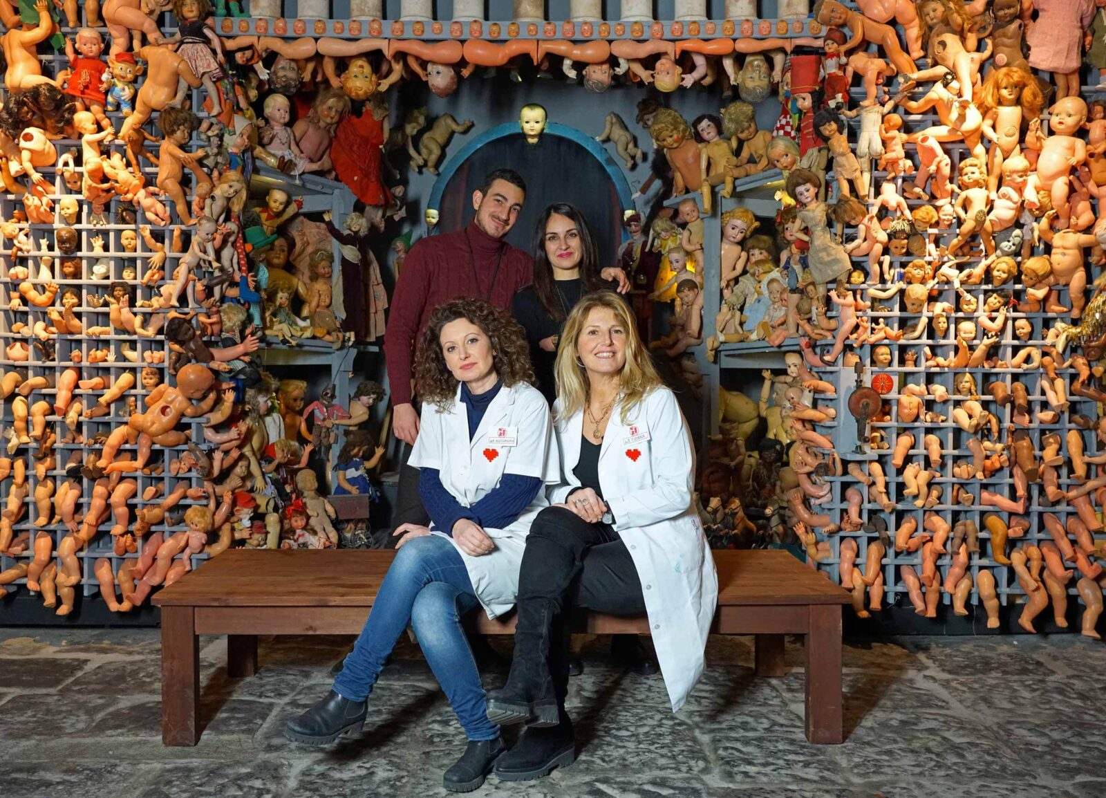 Dolls Hospital Naples - Photo of the team with dolls parts in the background
